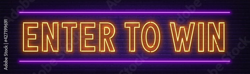 Enter to win neon sign on a brick wall background.