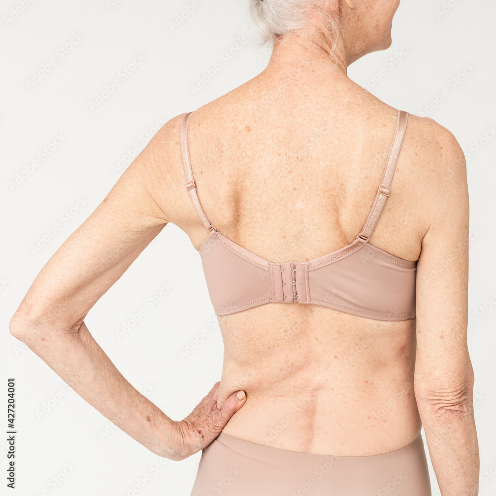 Senior women in brown lingerie studio portrait rear view Senior women in brown lingerie studio portrait rear view