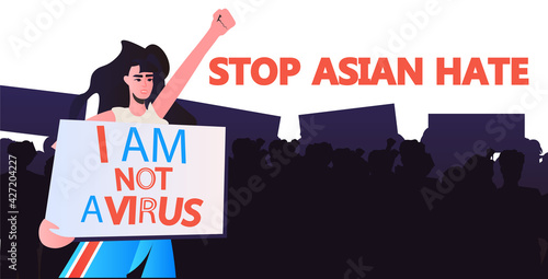 stop asian hate woman in mask holding banner against racism support people during coronavirus pandemic