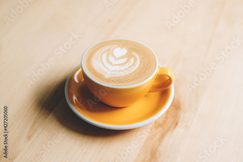 Fresh flavored coffee art is on the wooden table.