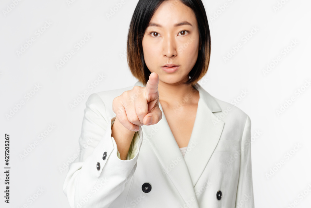Asian businesswoman touching virtual screen Asian businesswoman touching virtual screen