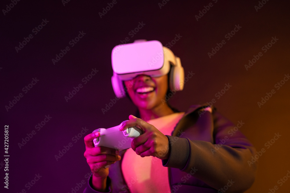 Woman playing game with VR headset virtual reality experience Woman playing game with VR headset virtual reality experience