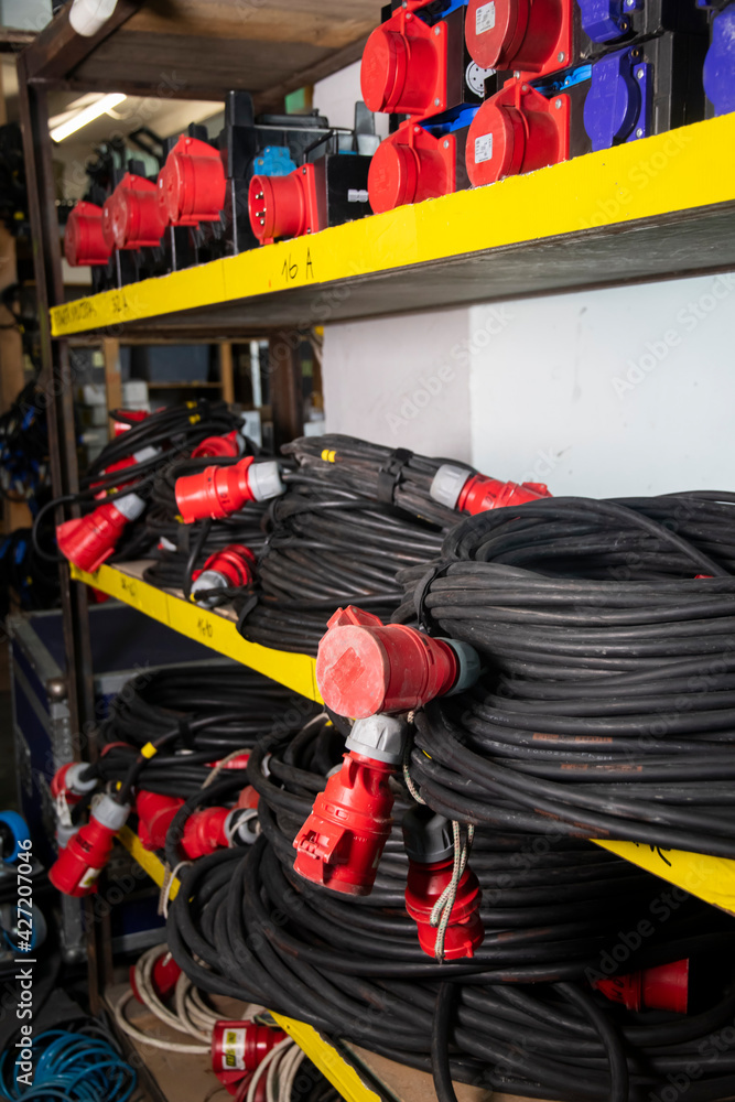 Black heavy extension cords on a shelf. Power Distributor 32A ...