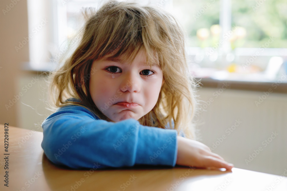 Cute upset unhappy toddler girl crying. Angry emotional child shouting. Portrait of kid with tears. Lonely child due to corona virus covid lockdown. Cute upset unhappy toddler girl crying. Angry emotional child shouting. Portrait of kid with tears. Lonely child due to corona virus covid lockdown.
