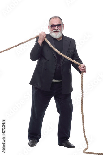 Mature businessman in glasses pulls the rope .