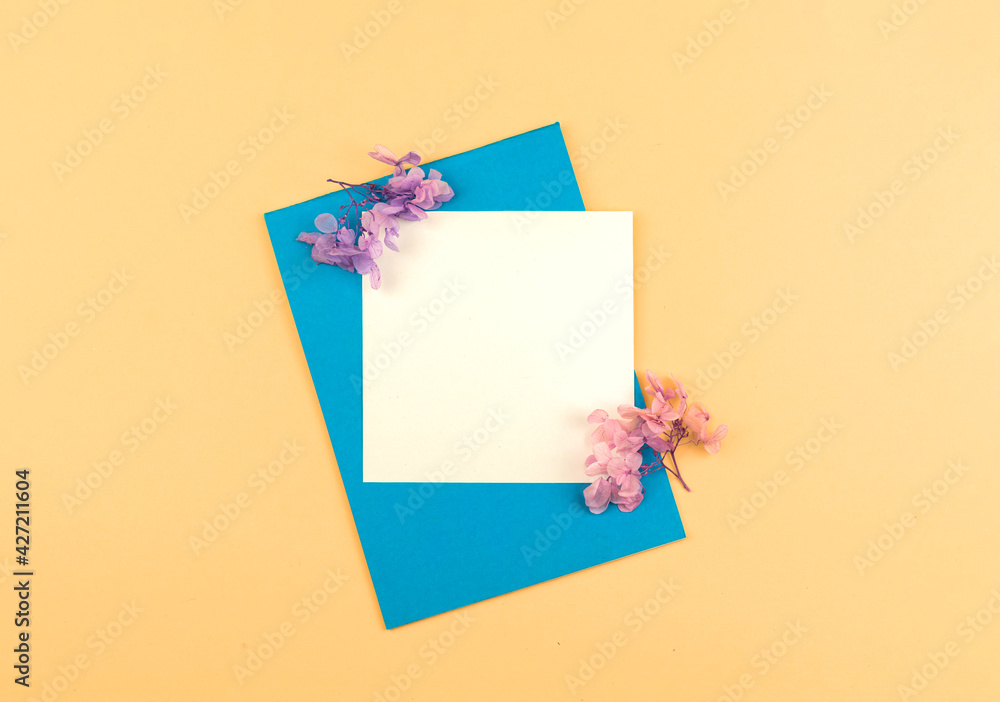 Minimal business template background with blank white card, flat lay floral composition with copy space Minimal business template background with blank white card, flat lay floral composition with copy space