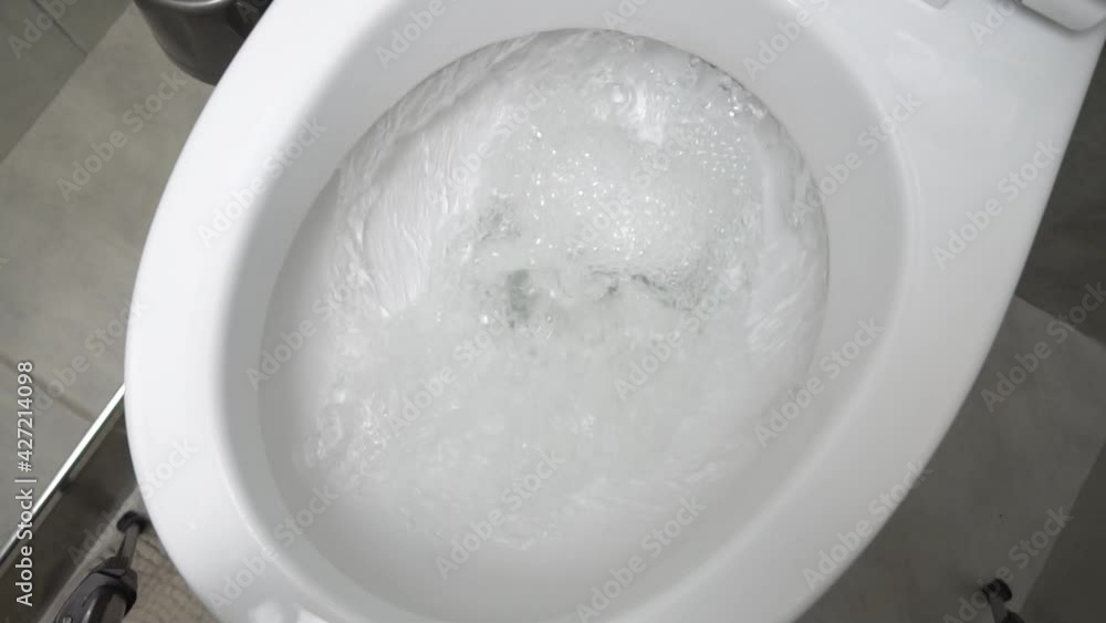 Flush toilet. Water flushes the toilet. The flow of water is clearly ...