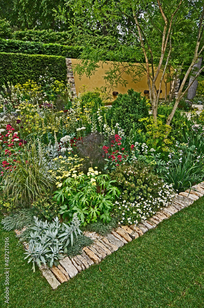 An impressive modern flower border with mixed planting