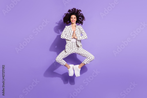 Full size photo of young excited girl happy positive smile jump wait expect wish isolated over purple color background