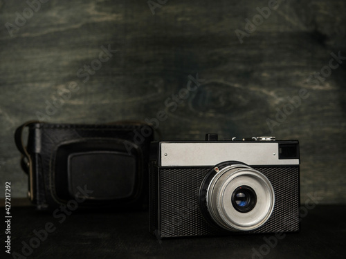 Vintage camera on a black background. Retro photo camera. Vintage.