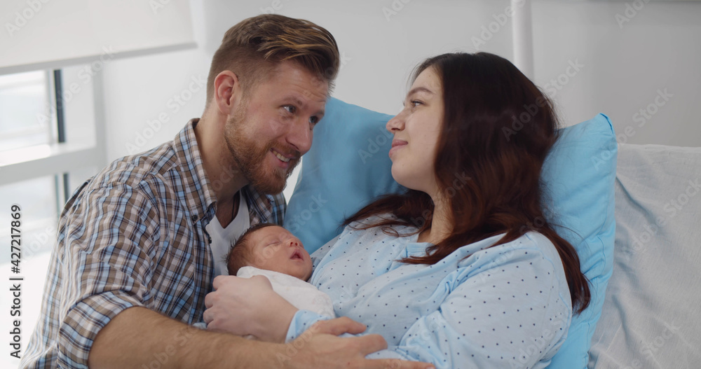 Happy mother and father with newborn baby at hospital Happy mother and father with newborn baby at hospital