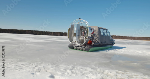 Foto Rescue team in hovercraft and sailing across frozen lake