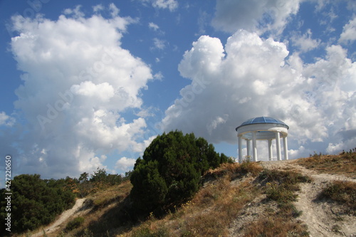 Beautiful clouds and mountains with a desert gazebo