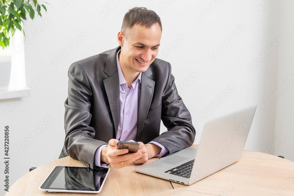 Handsome businessman working with laptop in office Handsome businessman working with laptop in office