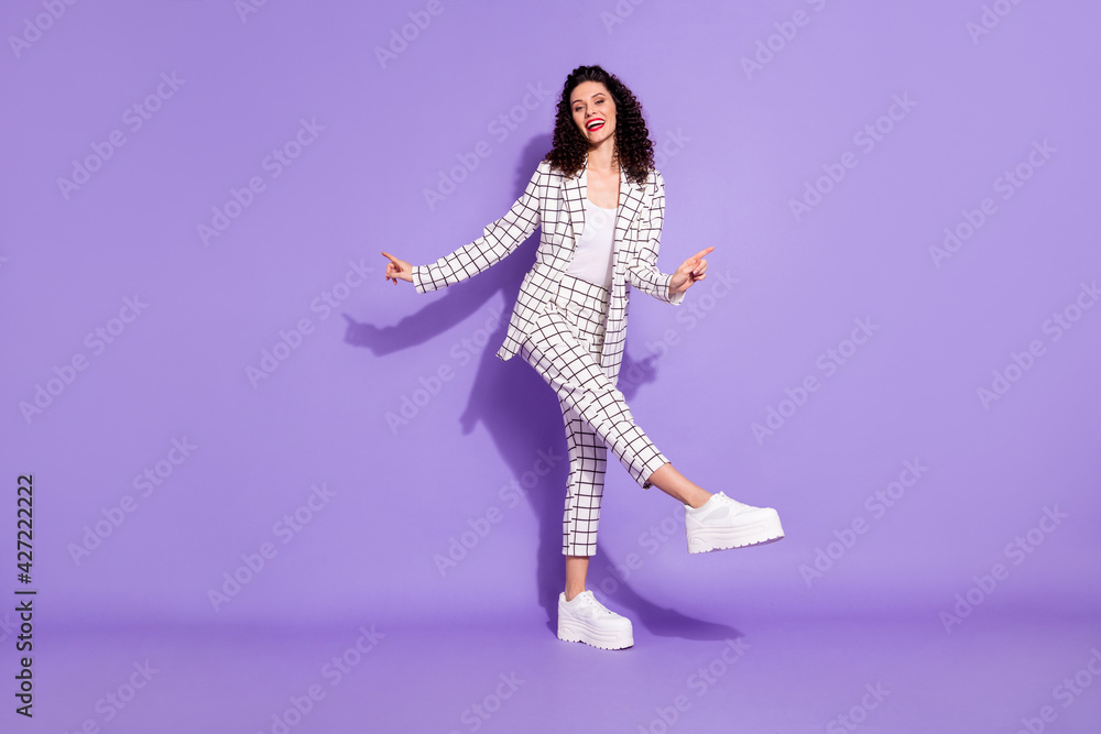 Full size portrait of adorable carefree lady dancing raise leg point fingers isolated on purple color background