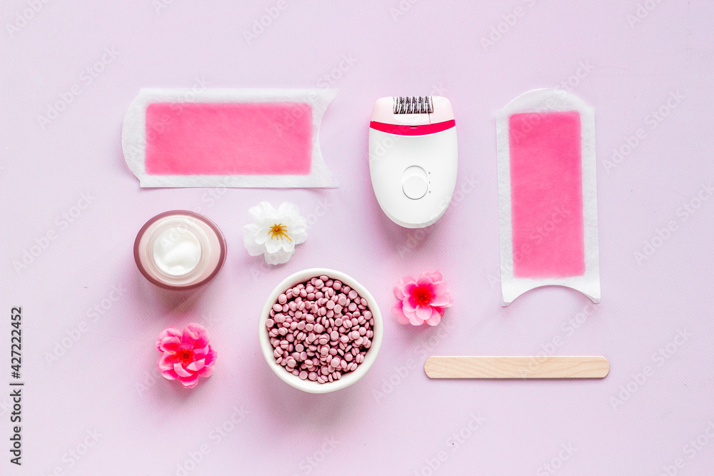 Set for epilation - epilator with wax strips and razor. Top view, flat lay Set for epilation - epilator with wax strips and razor. Top view, flat lay