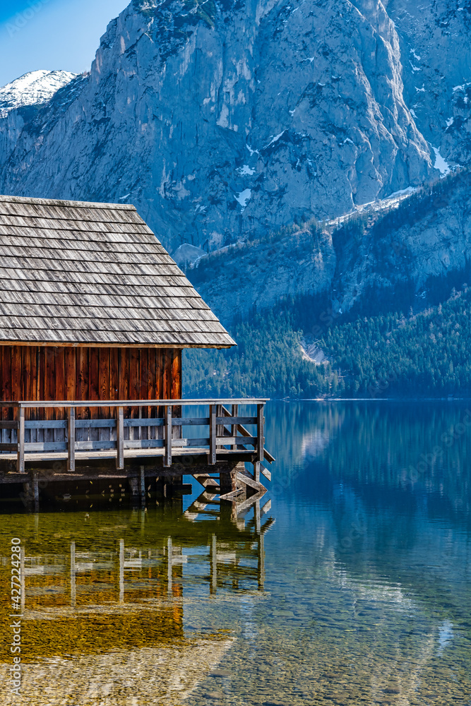 Idyllic View on Altausseer Lake with Wooden Hut reflecting in Water, Salzkamergut, Austria 05.04.2021 Idyllic View on Altausseer Lake with Wooden Hut reflecting in Water, Salzkamergut, Austria 05.04.2021