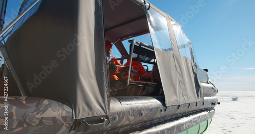 Billede på lærred Close up of rescue service team in hovercraft having emergency
