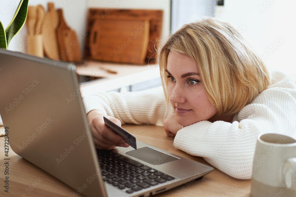 young woman buy online by credit card on the laptop young woman buy online by credit card on the laptop