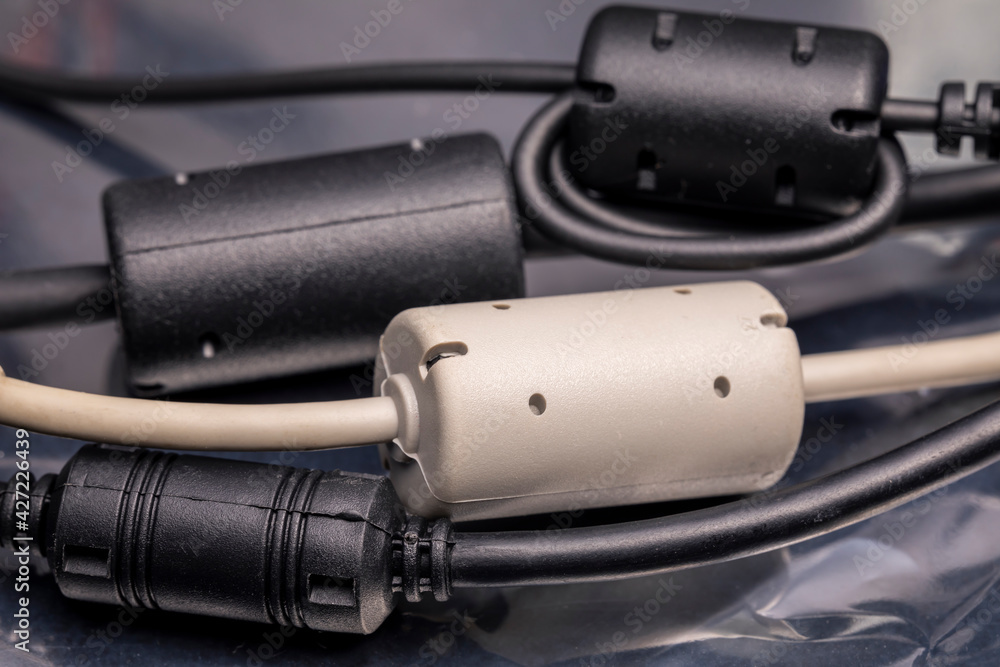 Close up of a ferrite bead inductor. An electrical element that suppresses high-frequency electronic noise in electronic circuits. Close up of a ferrite bead inductor. An electrical element that suppresses high-frequency electronic noise in electronic circuits.
