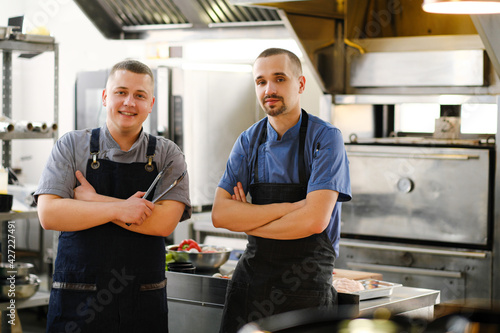 A young male Caucasian chef in the kitchen of the restaurant.