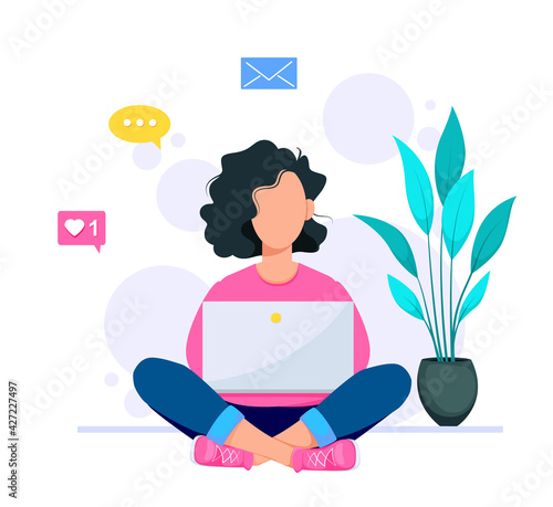 Happy young woman using her laptop at home