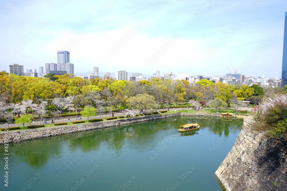 City landscape of Osaka, Japan with Osaka castle moat and Cherry blossoms - 大阪の都市景観 大阪城のお濠と桜 