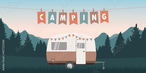 summer camper on green meadow with mountain view
