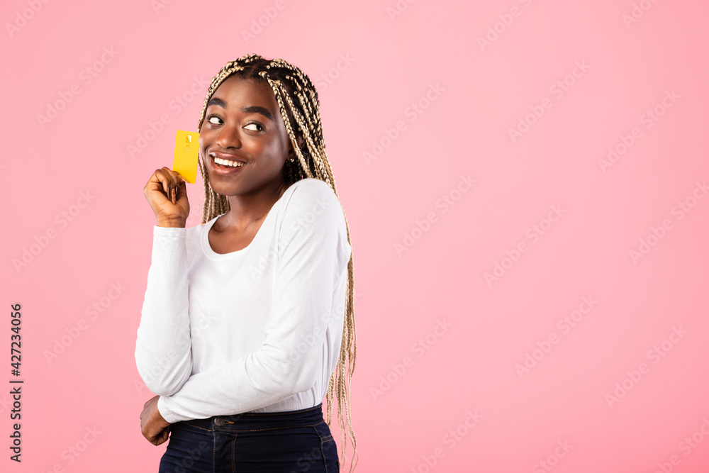 Black woman holding credit card and dreaming Black woman holding credit card and dreaming