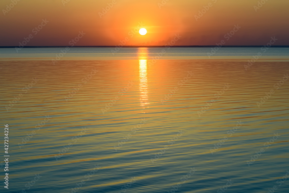 Bright beautiful sunset at the calm sea. Solar disk over water. Bright beautiful sunset at the calm sea. Solar disk over water.