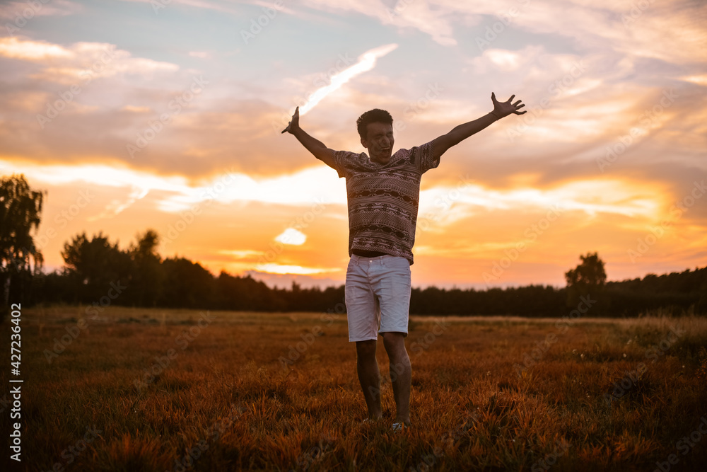 A man in the forest runs on the field, a happy man rejoices in freedom and tranquility. The guy in the field. A man in the forest runs on the field, a happy man rejoices in freedom and tranquility. The guy in the field.