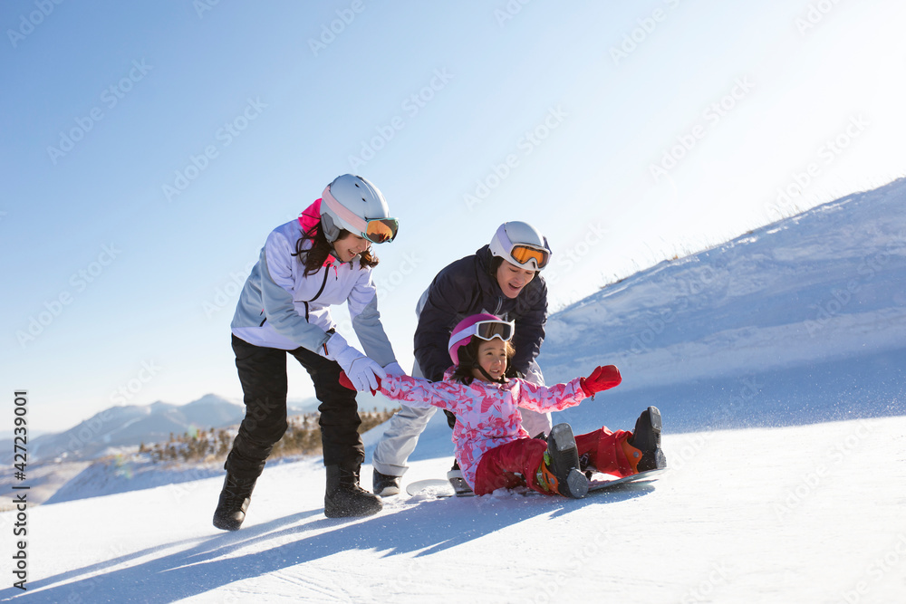 Happy young family relaxing in ski resort Happy young family relaxing in ski resort