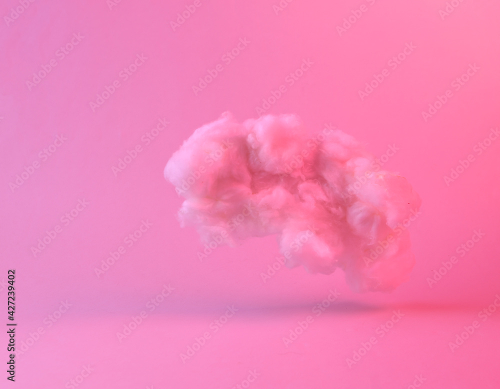 Floating fluffy cloud in pink neon gradient light. Dreams. Creative idea. Concept art. Minimalism