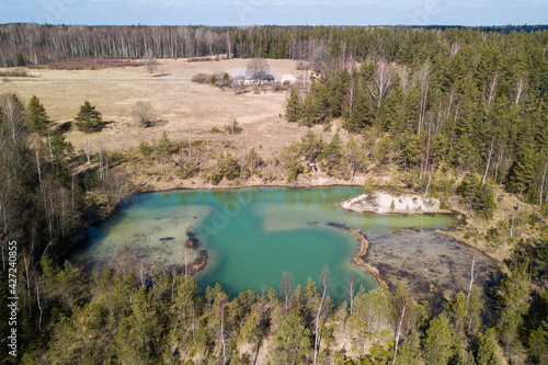 Aerial view of small green blue Lackroga lake, Latvia