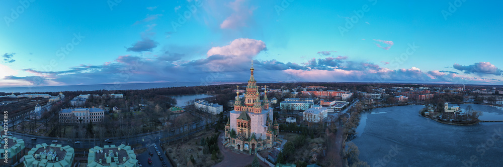 A panoramic Aerial view of the Cathedral of Saints Peter and Paul, golden domes in the beautiful setting sun. Orthodox church in Peterhof. Facade of the church close-up.