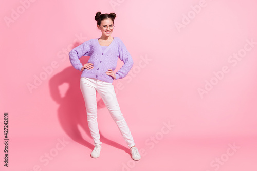 Full length body size photo of cheerful girl confident smiling wearing casual outfit isolated on pastel pink color background © deagreez