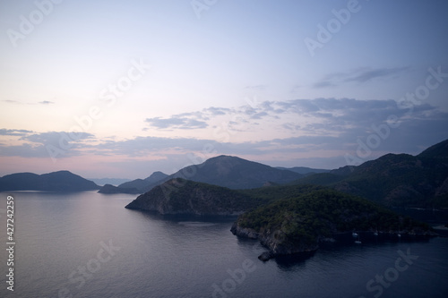 Aerial view of sea bay and mountains at sunset time.