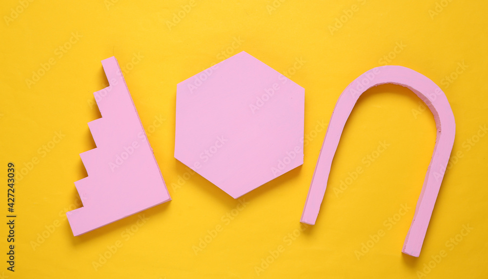 Layout composition of pink geometric shapes on yellow background. Flat lay Layout composition of pink geometric shapes on yellow background. Flat lay