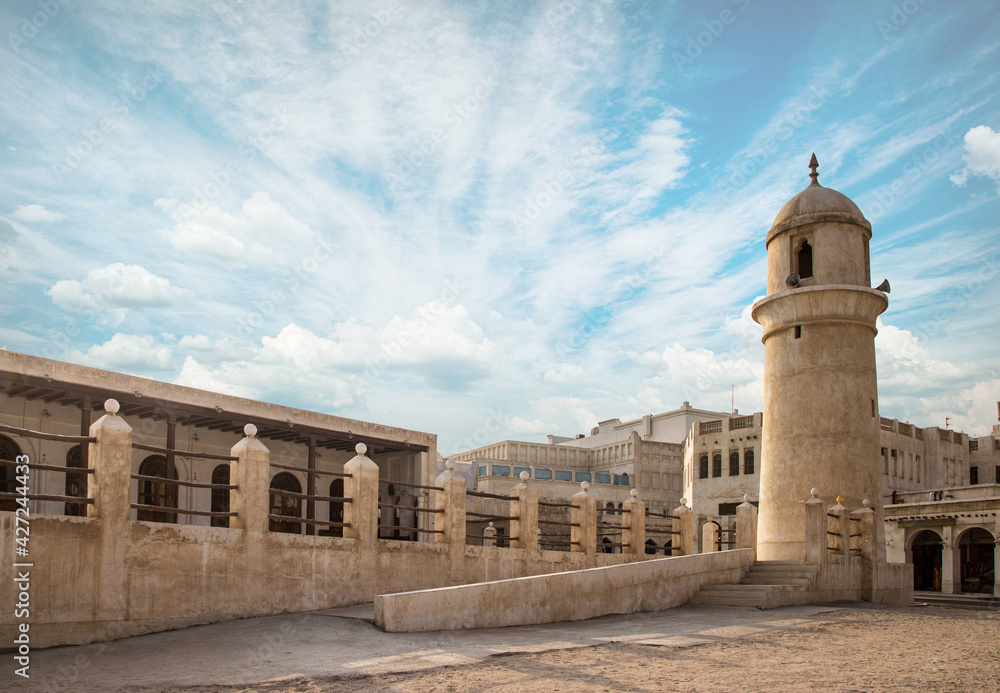 Old center, market and Al Ahmad Mosque in Doha. Islamic religion building. Souq Wakif is the popular traditional market in Doha, Qatar, Middle East.