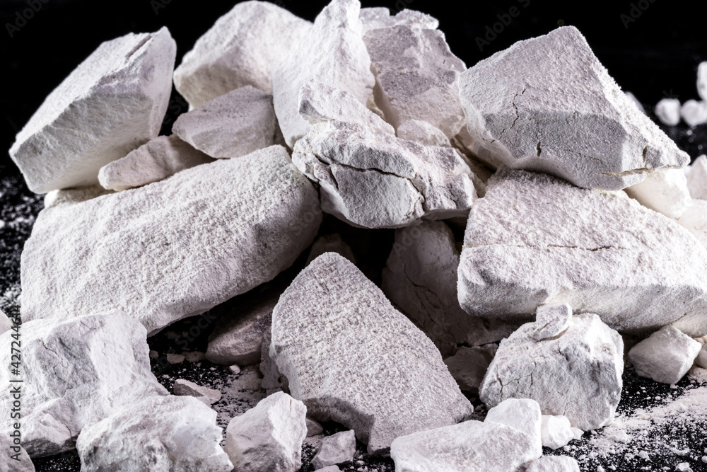 Calcium and Magnesium stones, black background. Called virgin lime or quicklime - obrazy, fototapety, plakaty 