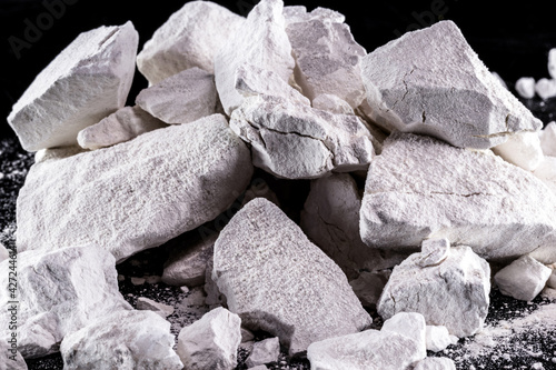 Calcium and Magnesium stones, black background. Called virgin lime or quicklime
