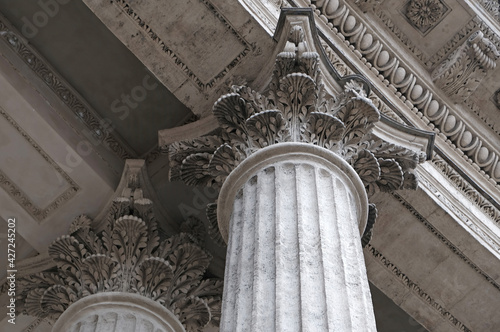 Classic architectural column. Details of the architecture of a historical building. Element of exterior building with columns and Stucco molding on the ceiling of Cathedral in St. Petersburg, Russia. photo