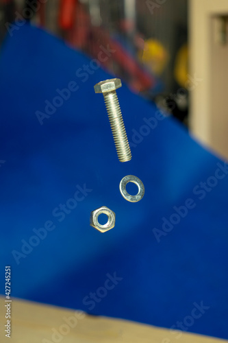 falling metal bolts and nuts with washers