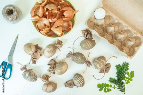 DIY instruction: traditional natural method for coloring eggs on Easter with decoction from onion peels, with leaves pattern. Step 5 of 7: repeat the whole procedure for every egg.
