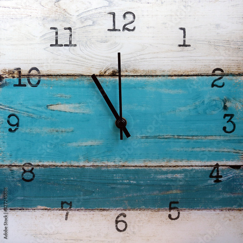 Wooden wall square clock. Eleven o'clock. Isolated