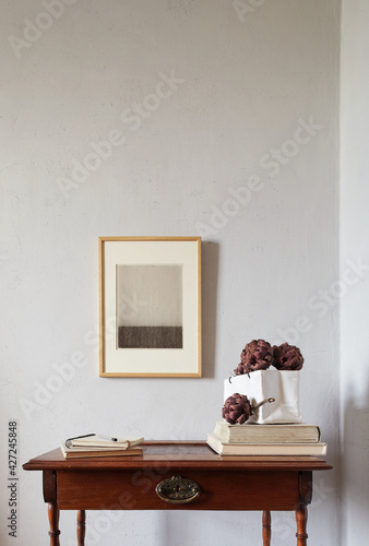 Wooden frames mockup. Dry decorative artichokes in a vase on an old wooden desk. Composition on a white wall background