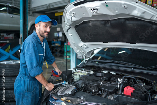 Auto services and Small business concepts. Auto mechanic hands using wrench to repair a car engine.