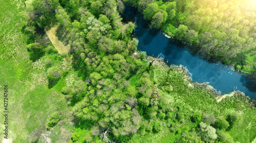 Aerial photo of river fragment. Background for a fishing theme. Spring nature. Top view from drone.