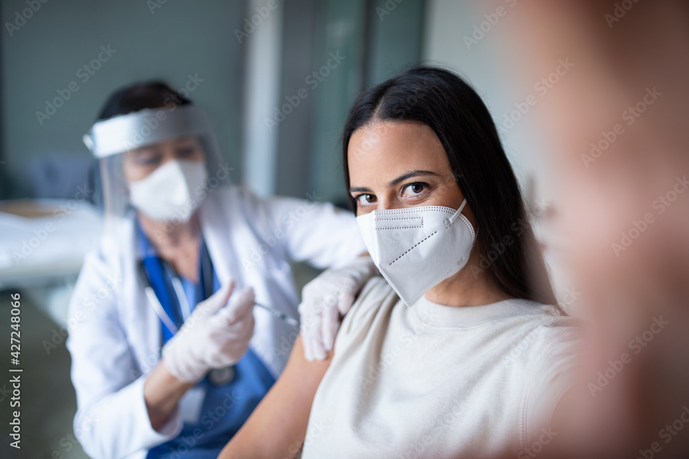 Woman with face mask getting vaccinated and taking selfie in hospital, coronavirus and vaccination concept. Woman with face mask getting vaccinated and taking selfie in hospital, coronavirus and vaccination concept.