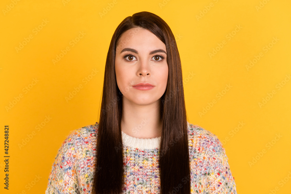 Photo of serious young charming woman wear colorful sweater isolated on shine bright yellow color background Photo of serious young charming woman wear colorful sweater isolated on shine bright yellow color background